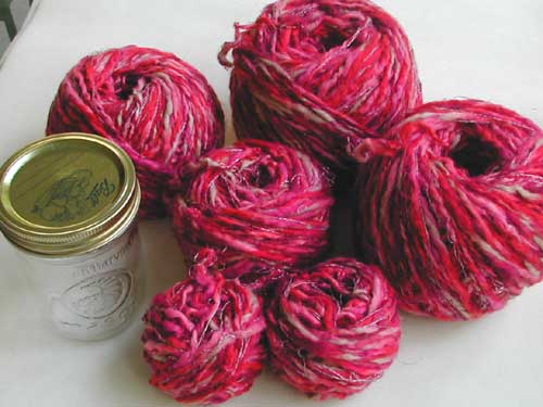 All of the balls of yarn from the sweater, with a wide-mouth pint canning 